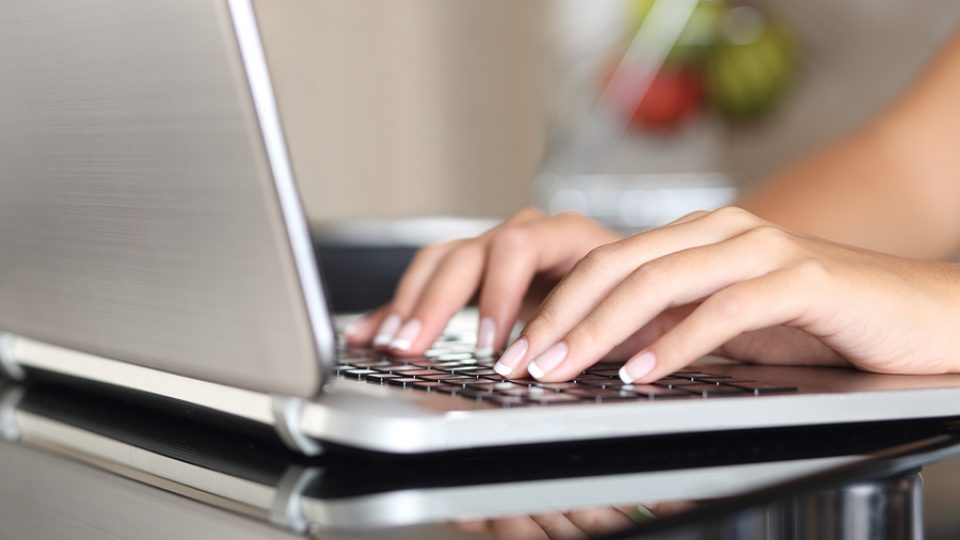 Woman Hands Working With A Laptop At Home